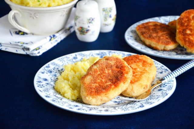 Minced chicken cutlets in a frying pan