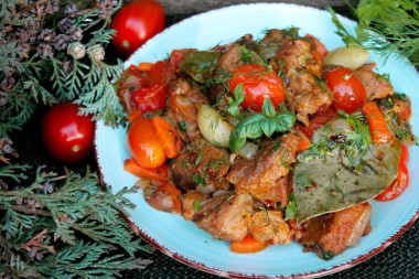 Pork meat in a cauldron over a fire