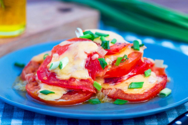 Tomatoes with cheese in a frying pan