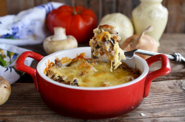 Mushrooms in sour cream with cheese and onions baked in the oven