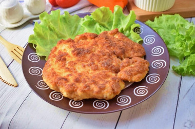 Breaded chicken schnitzel from breast in a frying pan