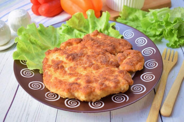 Breaded chicken schnitzel from breast in a frying pan