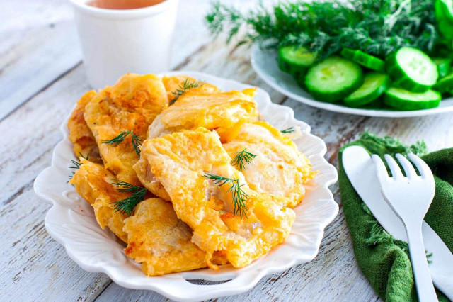 Pollock fillet in batter in a frying pan