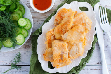 Pollock fillet in batter in a frying pan