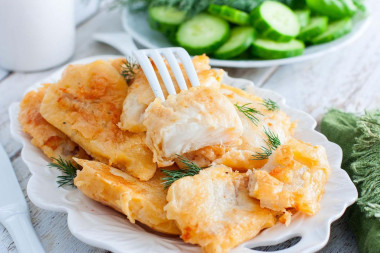 Pollock fillet in batter in a frying pan